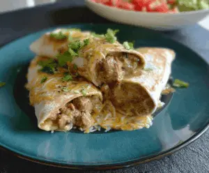 Delicious green chili burritos filled with savory ingredients, topped with melted cheese and fresh herbs, served on a plate