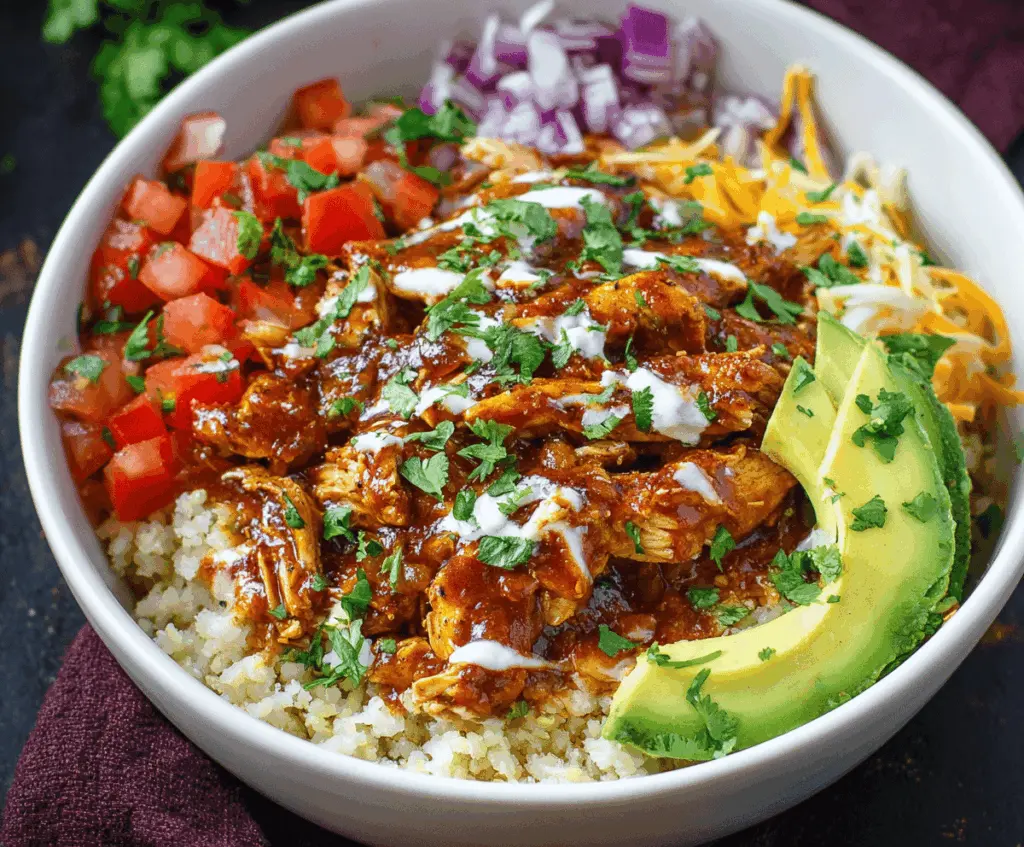 Delicious Chicken Enchilada Bowls served over healthy cauliflower rice, topped with melted cheese and fresh cilantro.