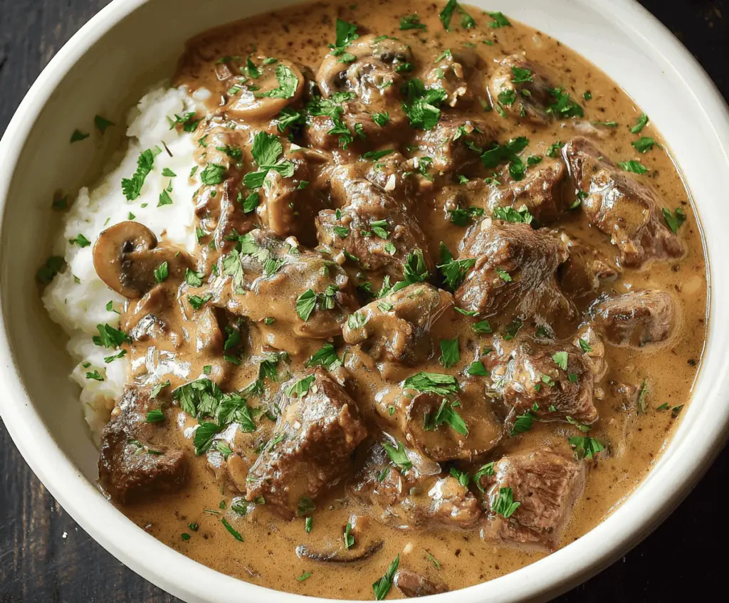 Creamy Slow Cooker Beef Stroganoff Stew served in a rustic bowl with tender beef and mushrooms.