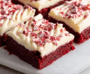 Delicious Red Velvet Cookie Bars with cream cheese frosting on a rustic platter